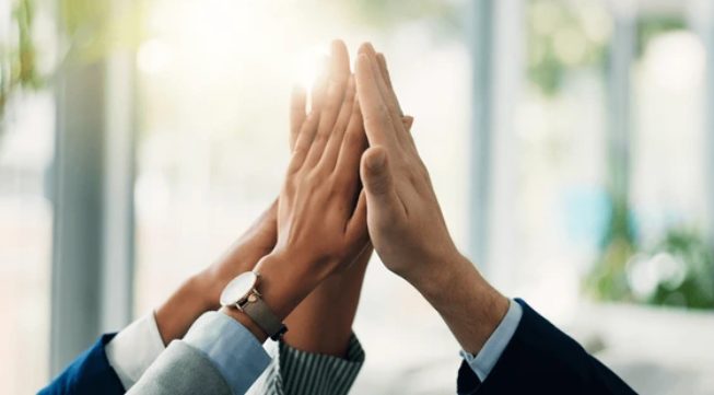 Leadership team sealing their commitment to the roadmap with a high-five