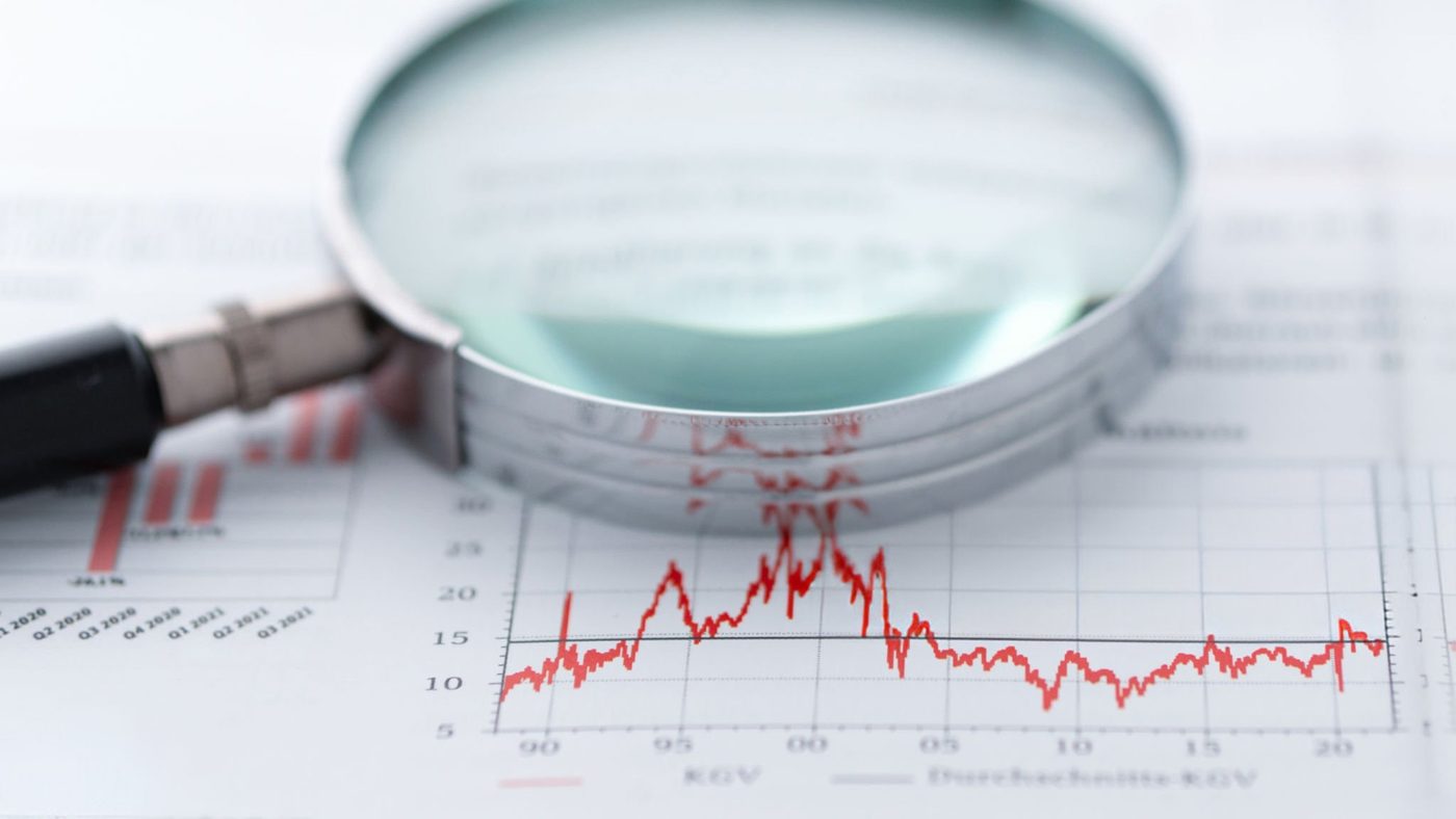 Magnifying glass over financial charts — a close look at what's actually driving performance.